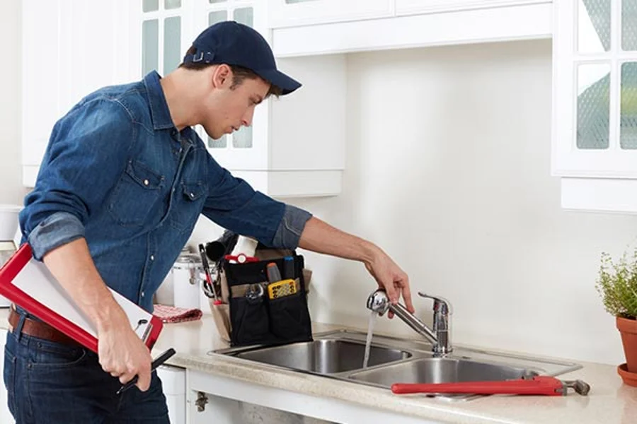Skilled Plumber Fixing a Kitchen Sink Leak